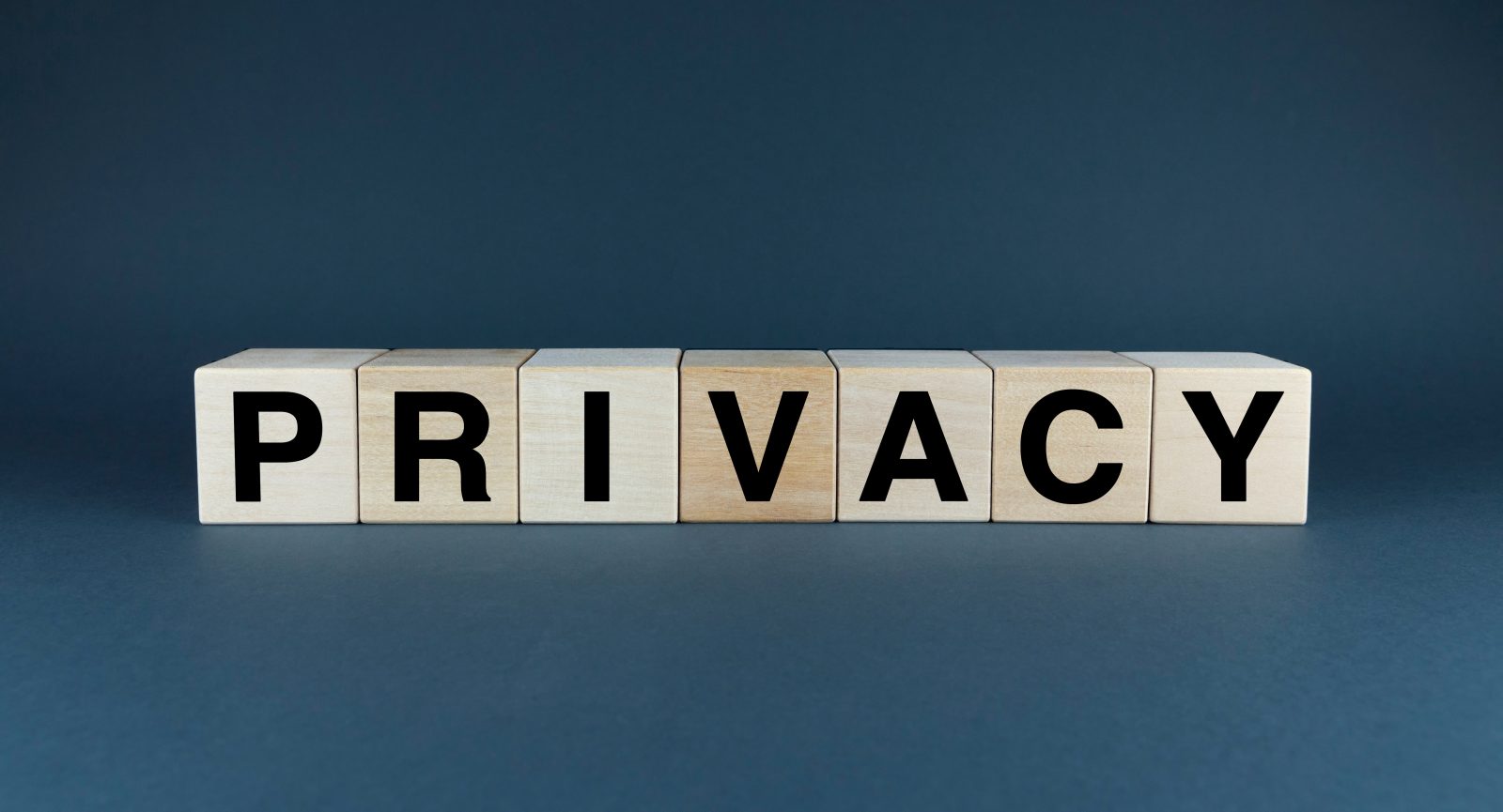 A conceptual image representing the importance of data privacy. The word 'PRIVACY' the need for protection of personal information, privacy spelled with scrabble letters