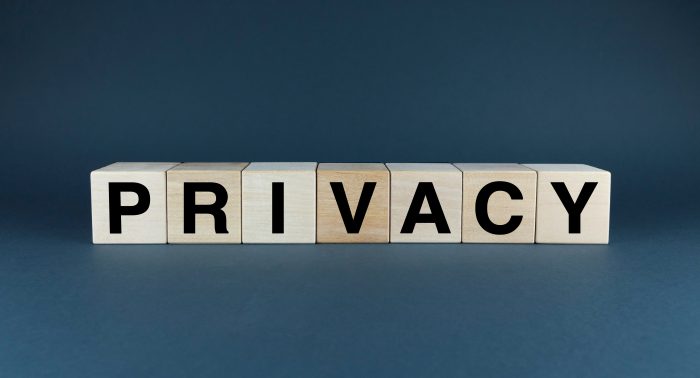 A conceptual image representing the importance of data privacy. The word 'PRIVACY' the need for protection of personal information, privacy spelled with scrabble letters