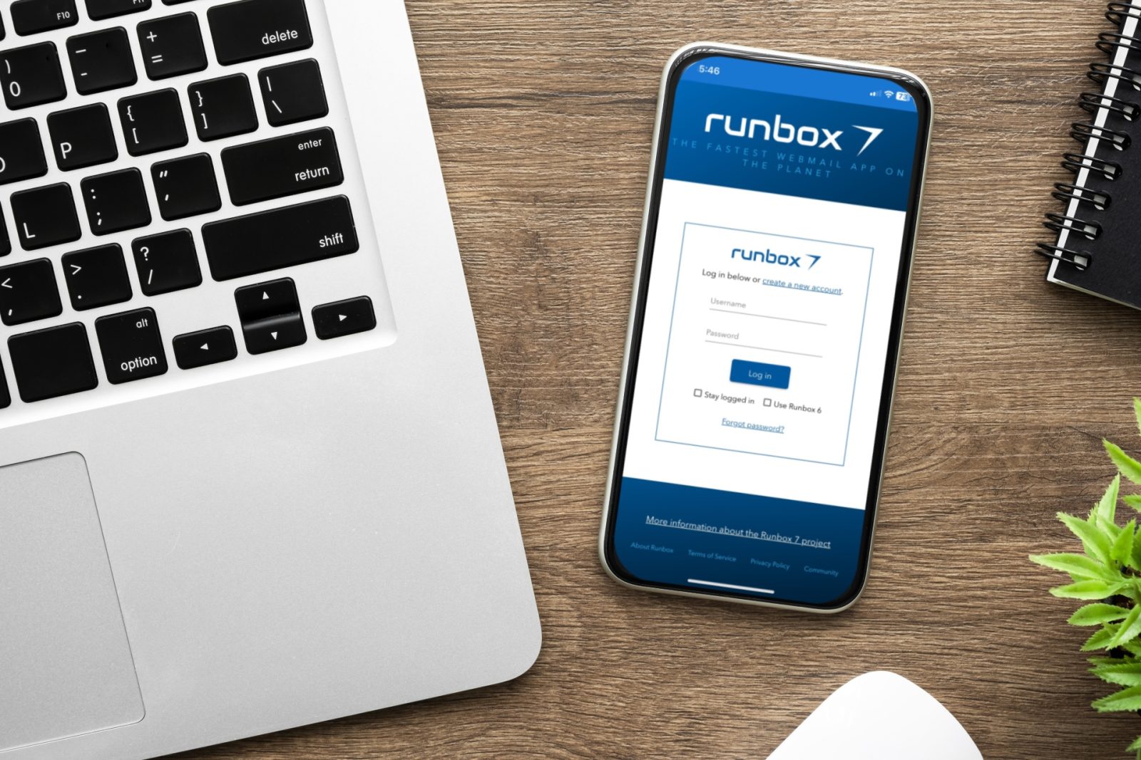Mobile phone with Runbox progressive mobile app login screen on a desk