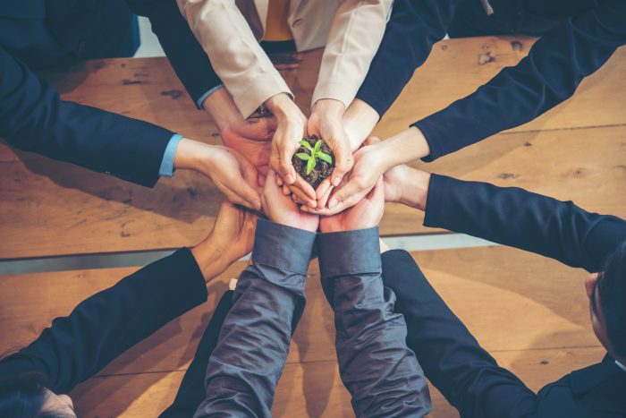 United Partners Team with hands together