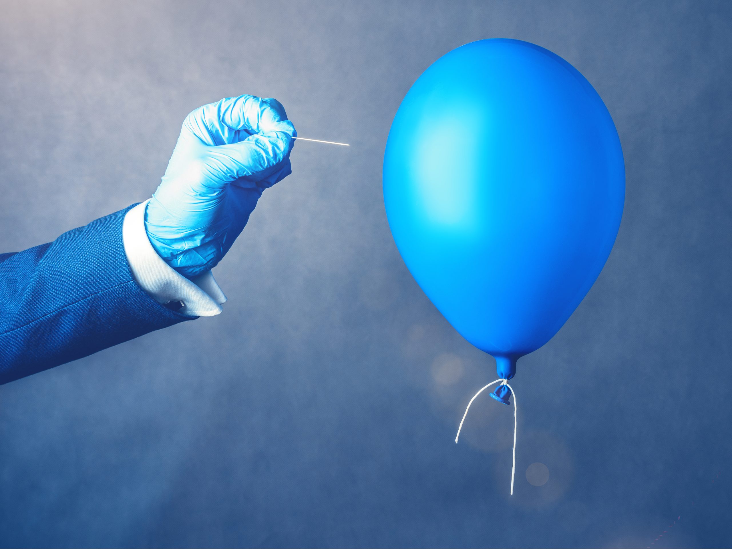 Blue balloon. Man hold needle directed to air balloon. Concept of risk. 